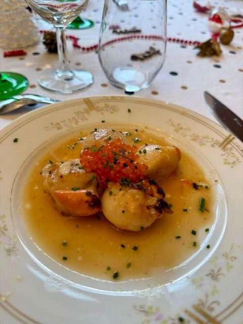 Seared scallops in beurre blanc sauce topped with trout roe and chives