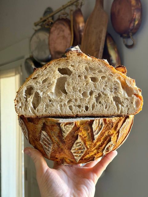 A sliced Tartine-style sourdough loaf showing an open crumb