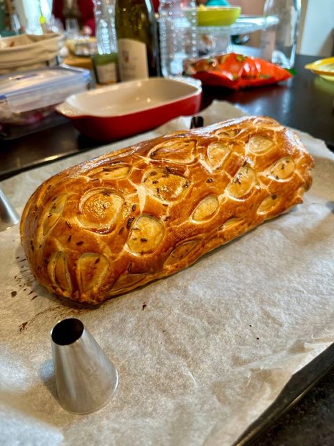 Whole baked beef Wellington with a golden decorated puff pastry crust